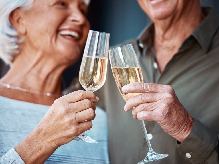 Mature couple toasting with Champagne glasses