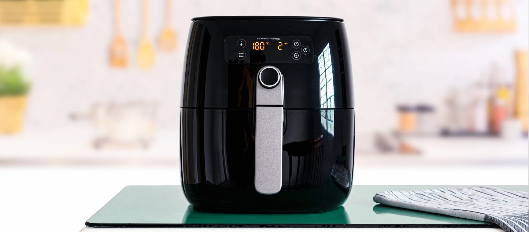 Black air fryer in a kitchen setting