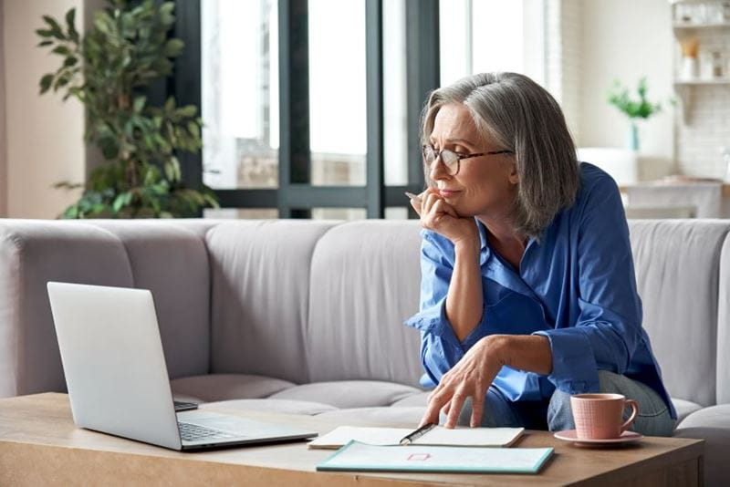 Woman looking at her laptop booking a trip