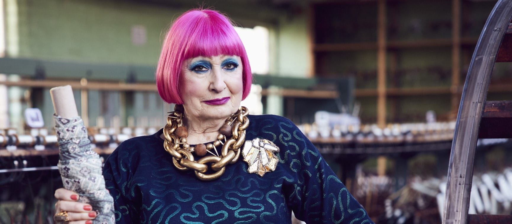 Zandra Rhodes holding a roll of fabric | Alun Callender