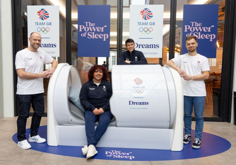 Members of the UK Olympic team and trainers with a Dreams sleep pod