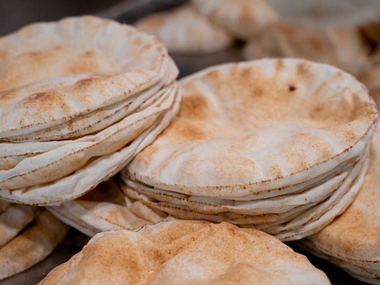 a pile of white pitta breads