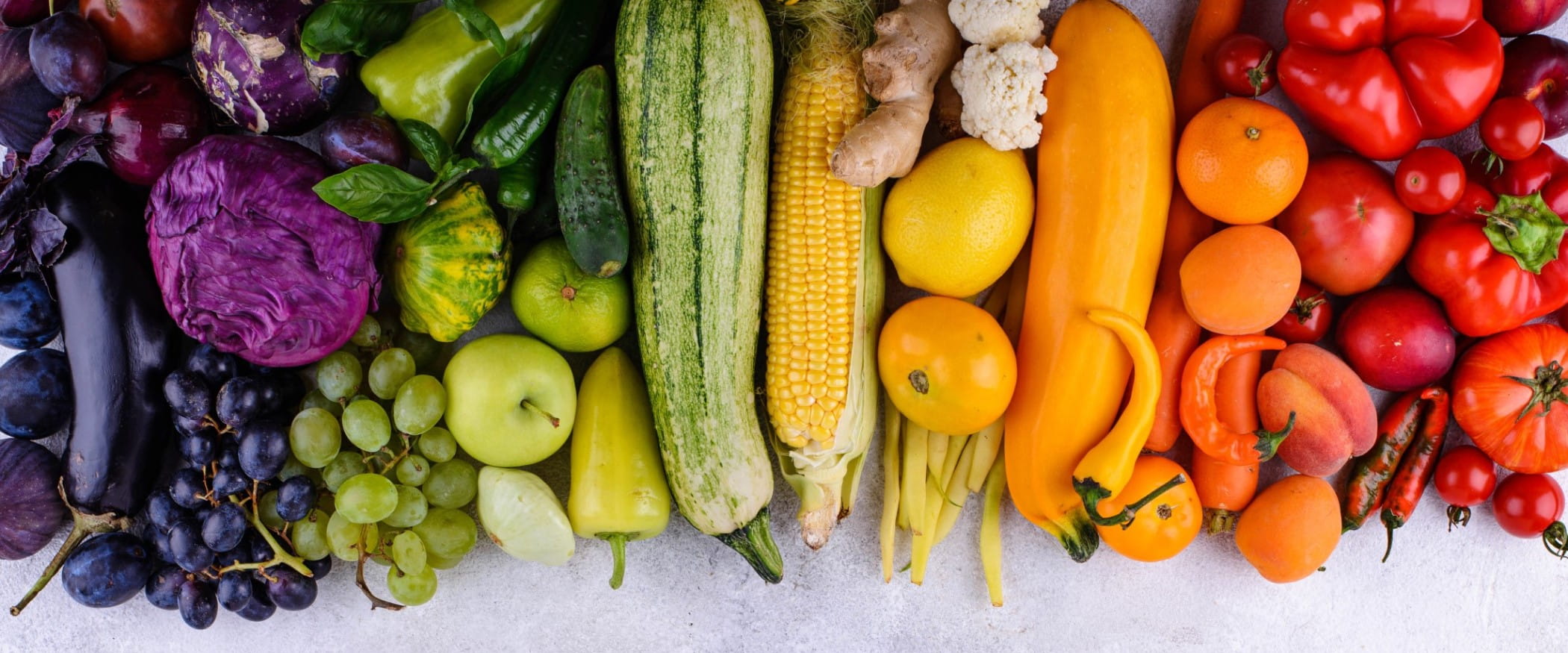 Assortment of red, yellow, green, orange, purple vegetables and fruits | Getty/yulka3ice