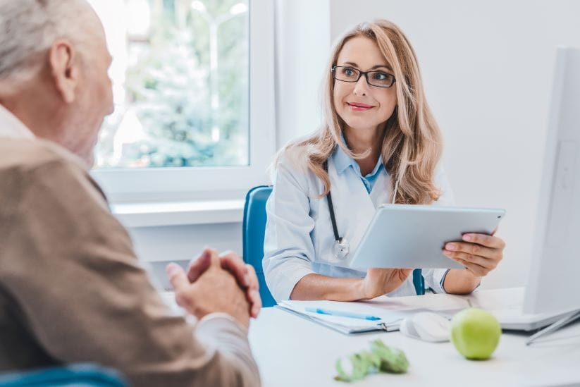 a man having a consultation with a woman doctor