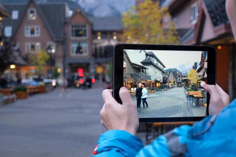 Taking a picture of a couple against a landmark