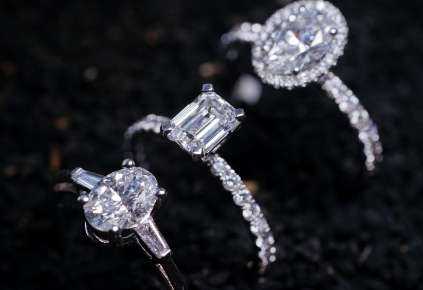 3 natural diamond rings on a black background