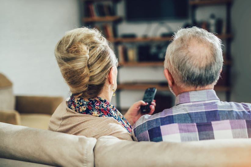 couple sitting down to watch tv