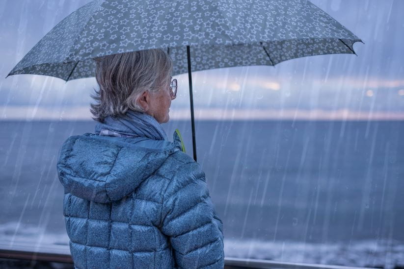 a woman holding an umbrella in heavy rain