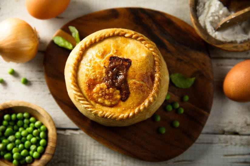 Steak and ale pie with some peas and onion