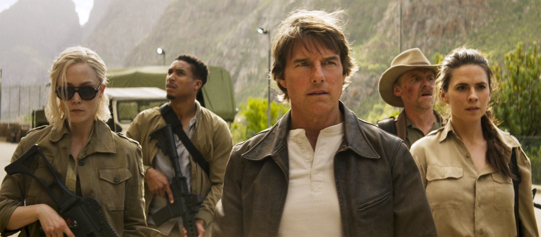 Tom Cruise and the cast in Mission Impossible dressed in combat gear with guns