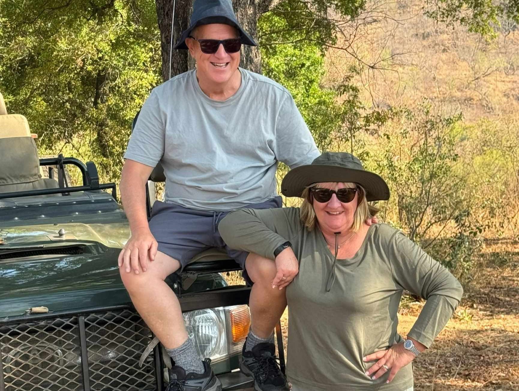 Steve and Viv on safari by a jeep