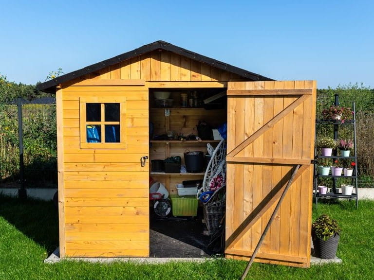 shed with an open door and good shelving inside