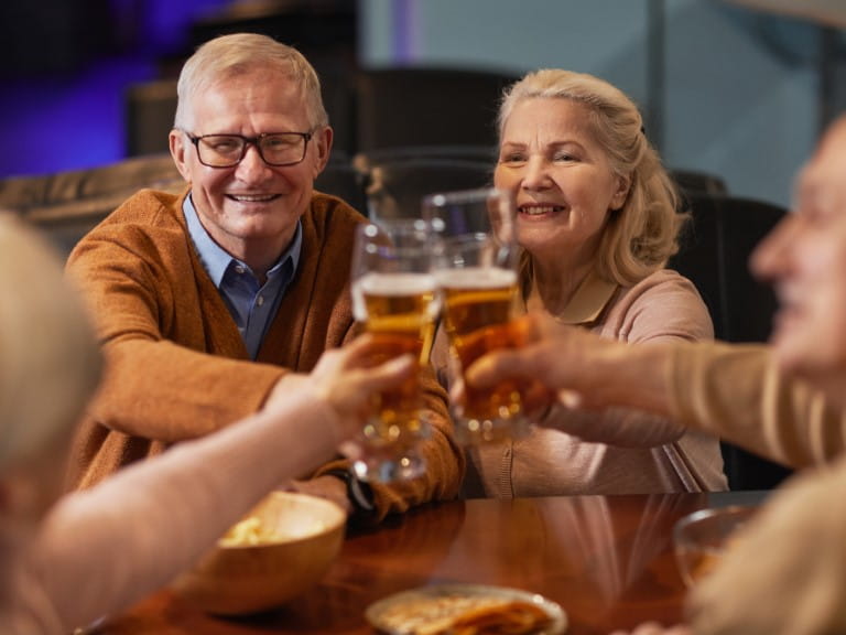 A group of older people enjoying non-alcoholic beers