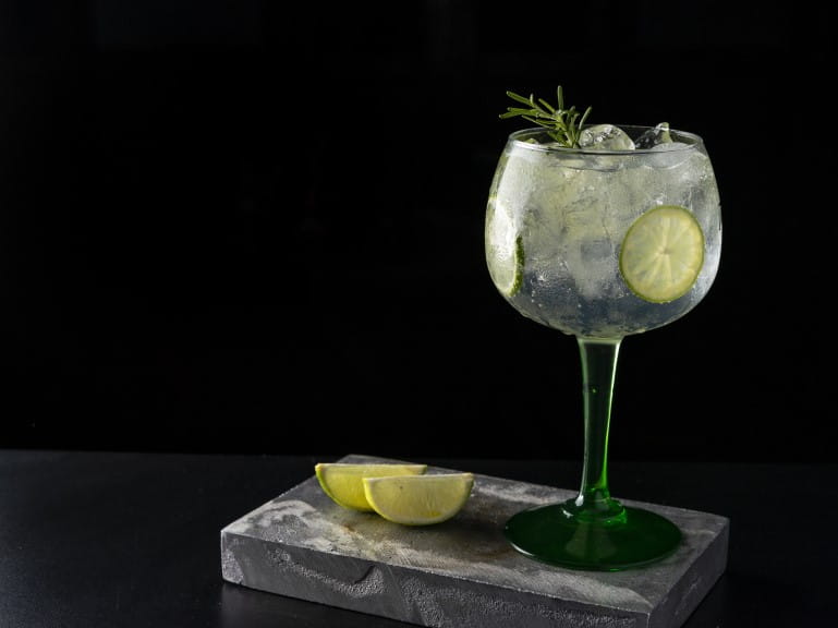 Gin and tonic in a large glass with lemon