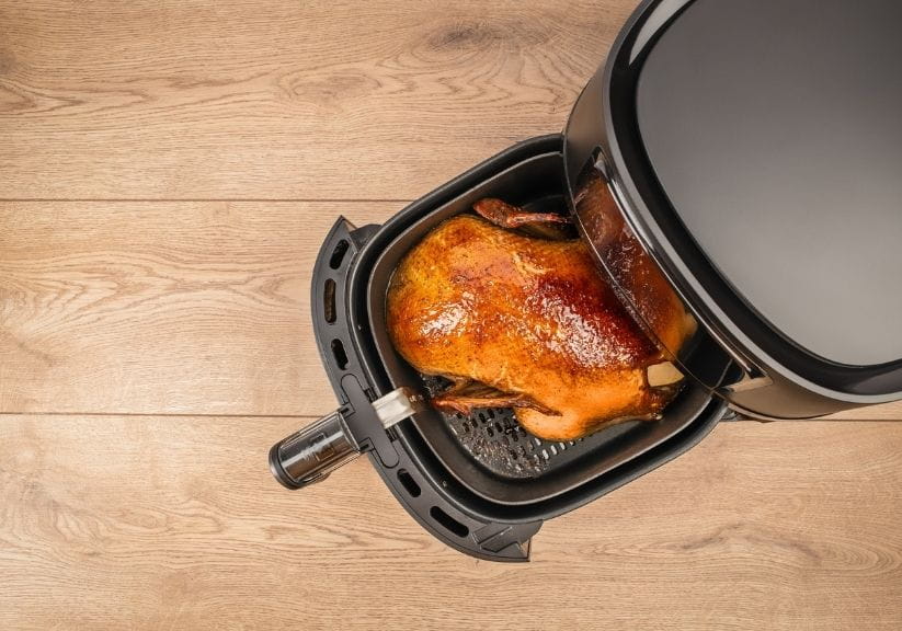 A duck being cooked in an air fryer