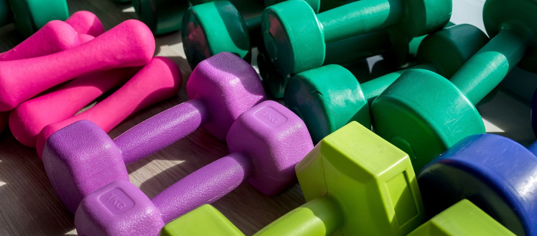 A range of brightly coloured dumbbells