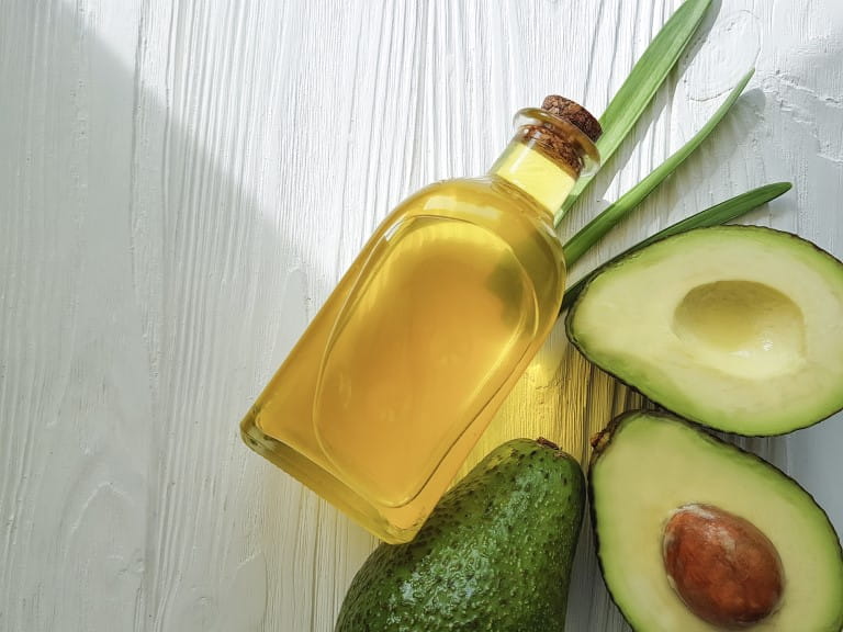 Avocados and a bottle of Avocado oil