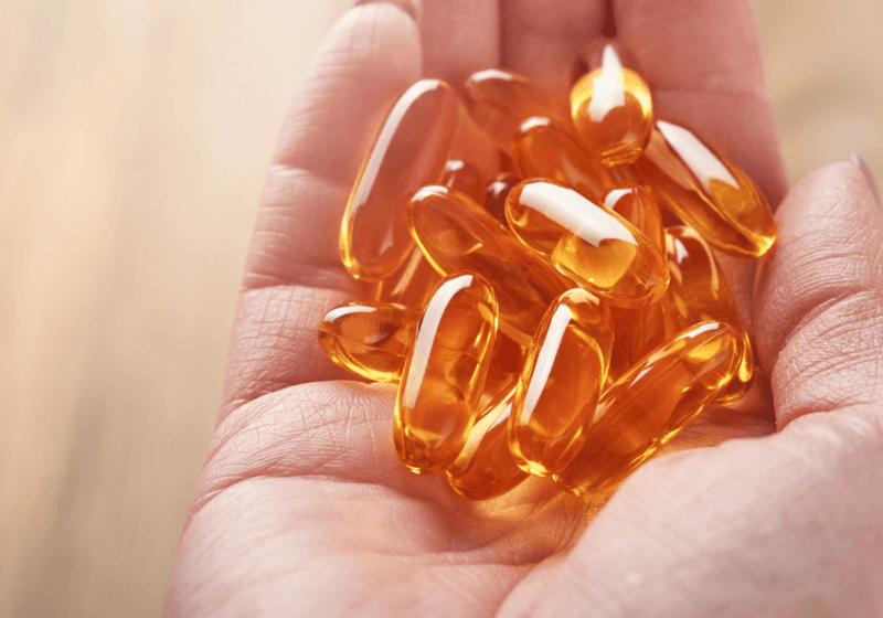 omega 3 oil capsules being held in a hand