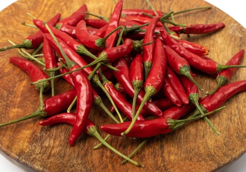 a selection of red chillies in a wooden bowl