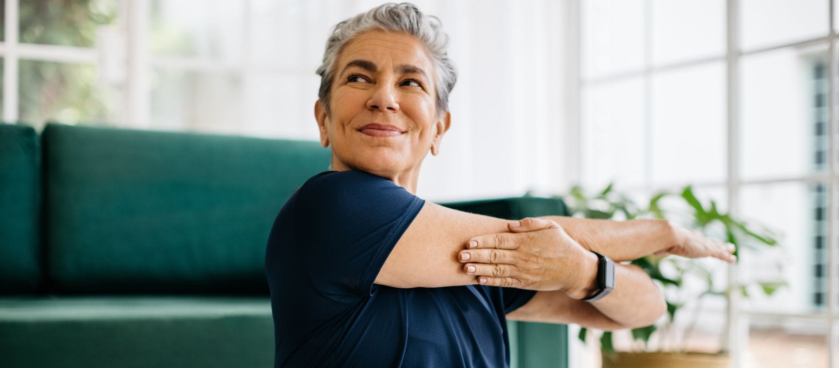 A lady stretching her arms after exercising