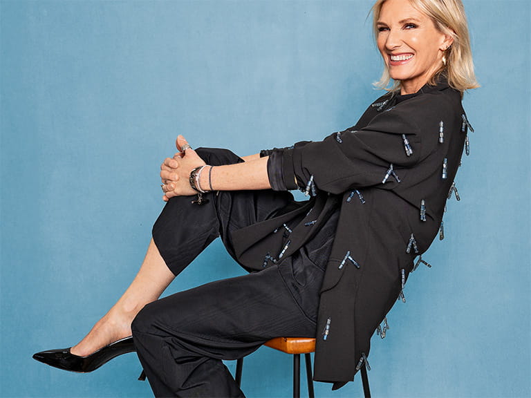 Jo Whiley posing on a chair during her Saga Magazine photoshoot