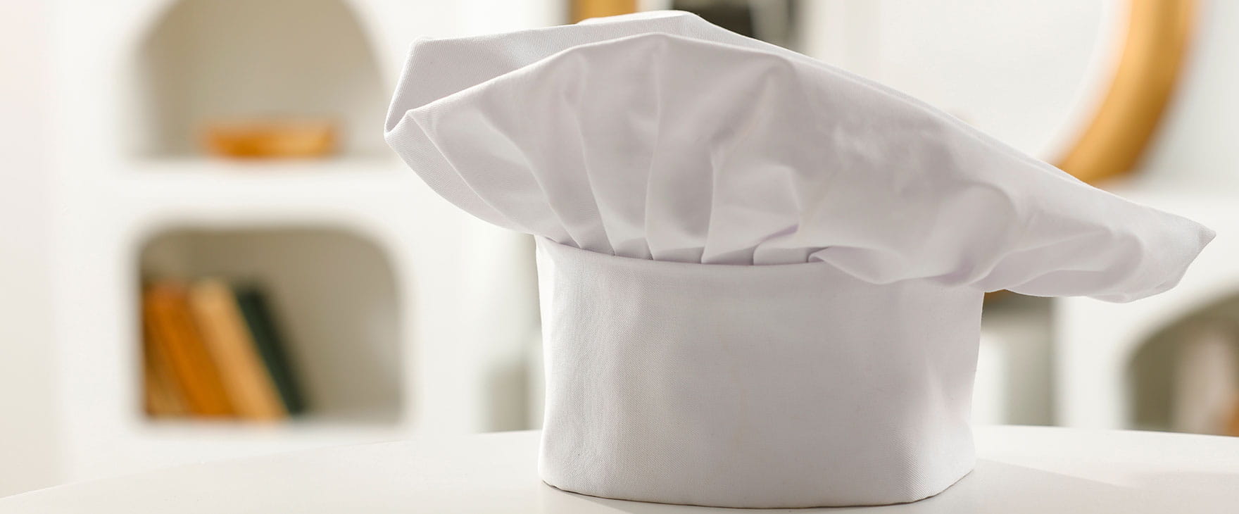 A chef's hat on a counter top