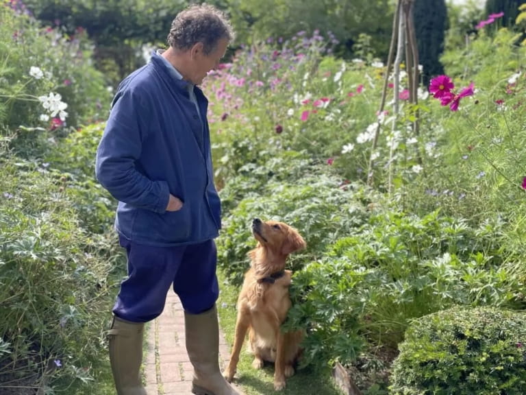 Monty Don and his dog Ned in the garden