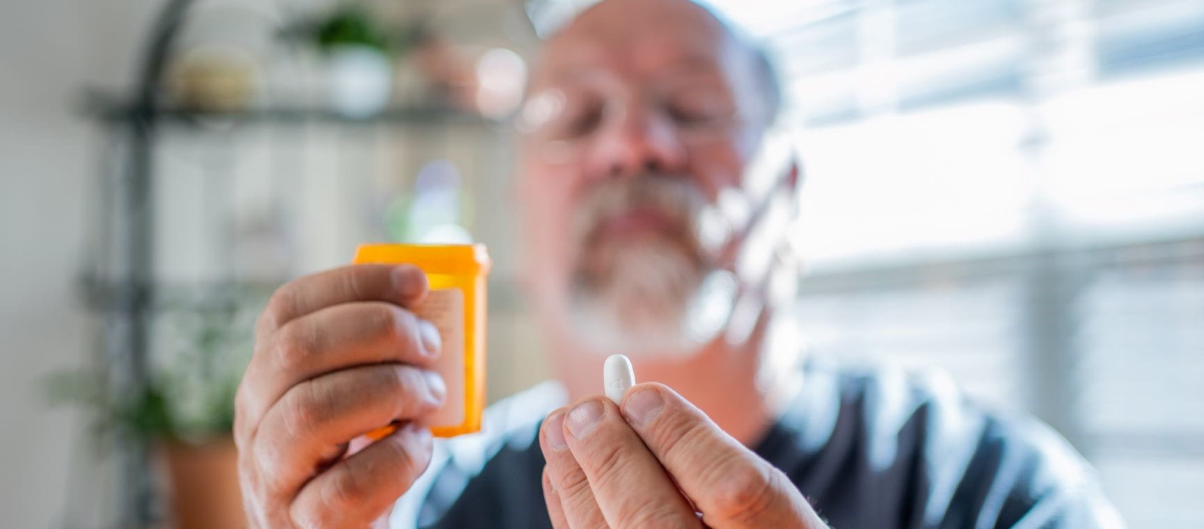Man looking intently at his prescription