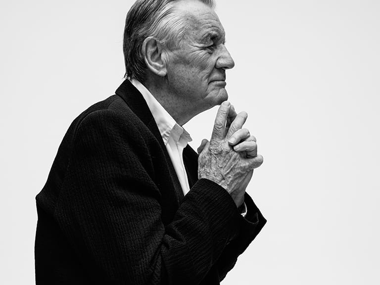 Michael Palin sat down with his hands clasped under his chin pensively