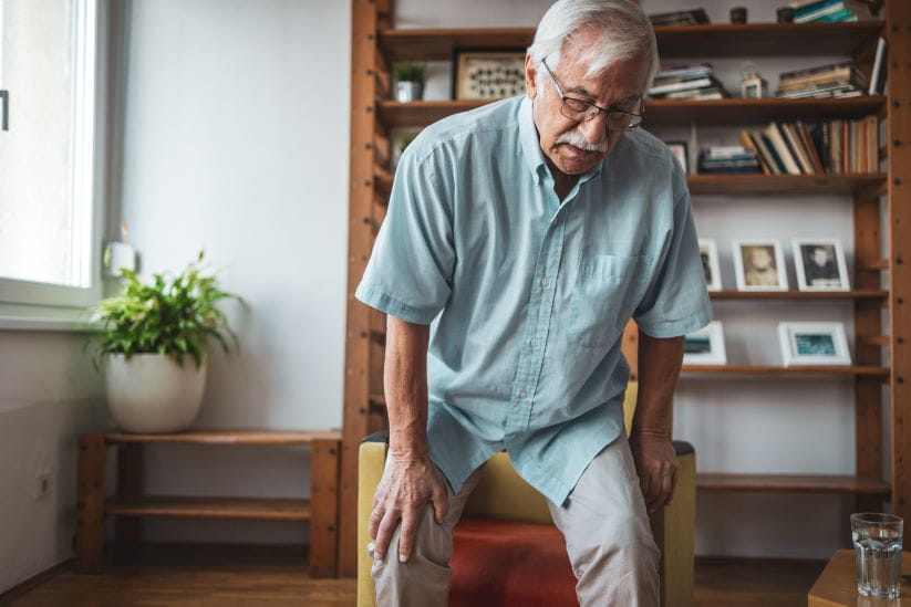 Man attempting to get up from his chair