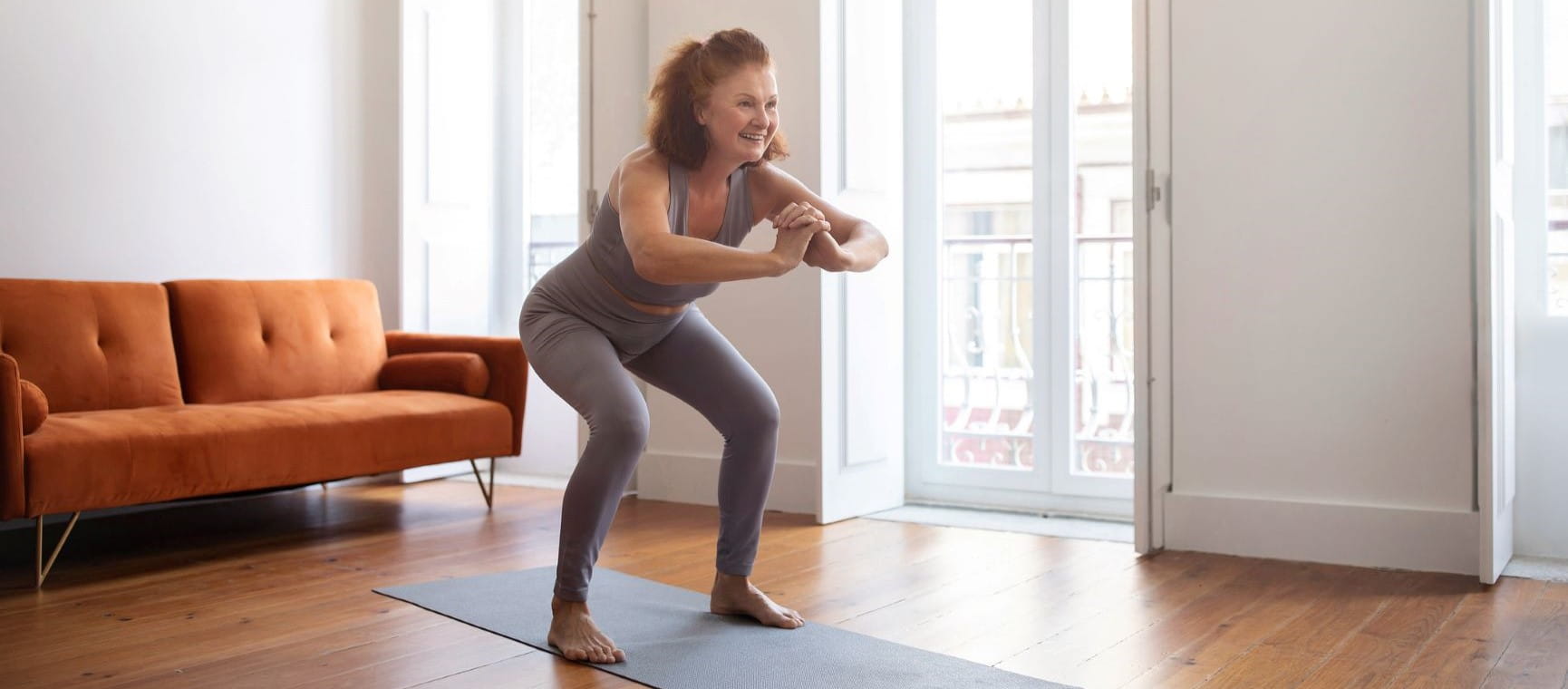 woman doing a squat in her lounge