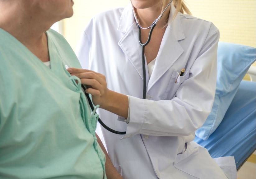 a doctor checking the heart rate of a patient