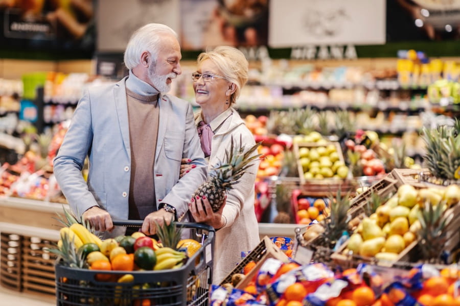 Senior couple with a basket of fruit