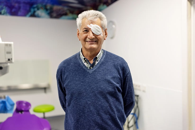 An older man smiling after a successful cataract surgery