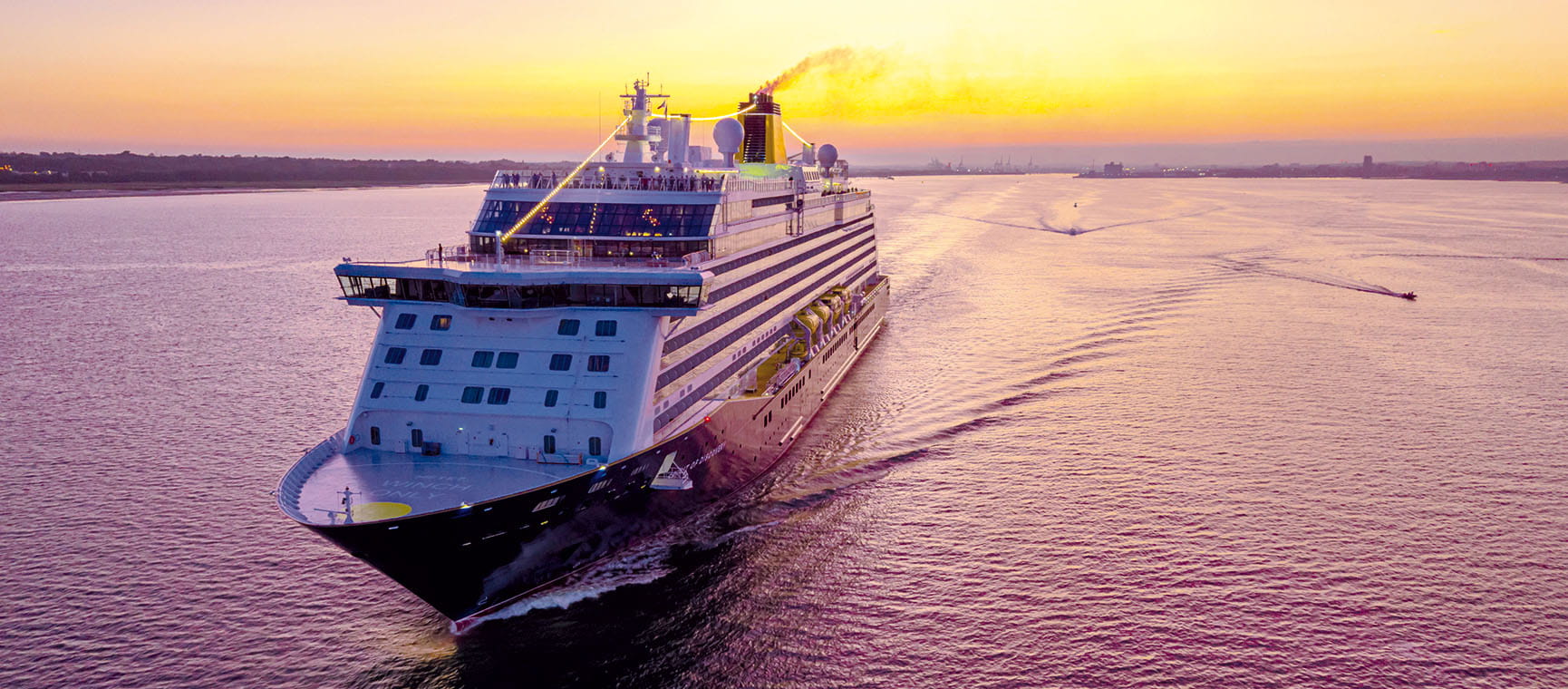 The Spirit of Discovery at sea at sunset