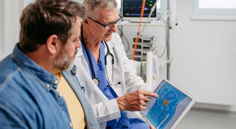 Doctor showing a man the result of his prostate screening test