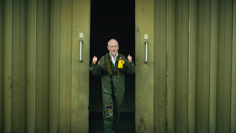 Jeremy Taylor in flight suit giving a double thumbs up