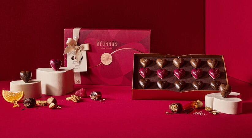 Love Letter Box Symphony of Love chocolates against a red background