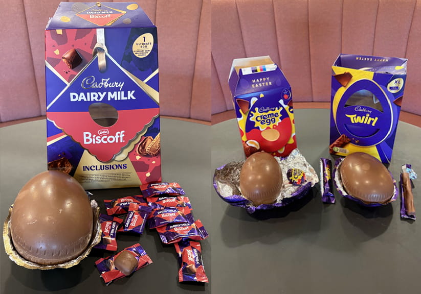 Three Cadbury easter eggs half-removed from their wrappers and in front of their packaging boxes