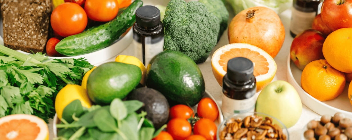 a variety of healthy foods with vitamin bottles