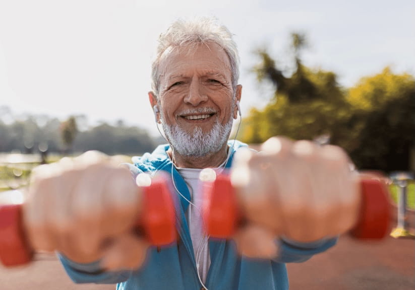 On older man using hand weights