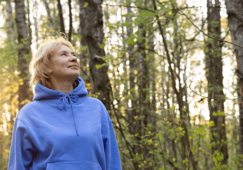 a woman walking in the woods