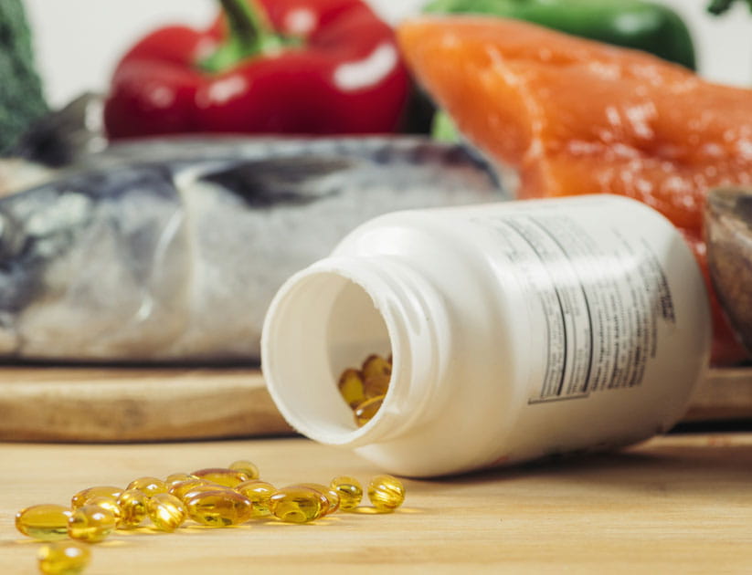 Supplement Bottle with Gel Capsules On a Wooden Table