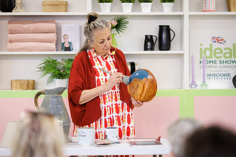 A wooden bowl being painted at Ideal Home Show