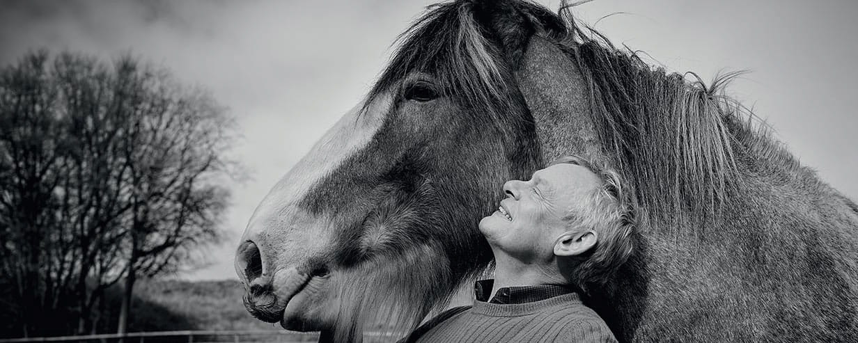 Black and white photo of Martin Clunes with his pony