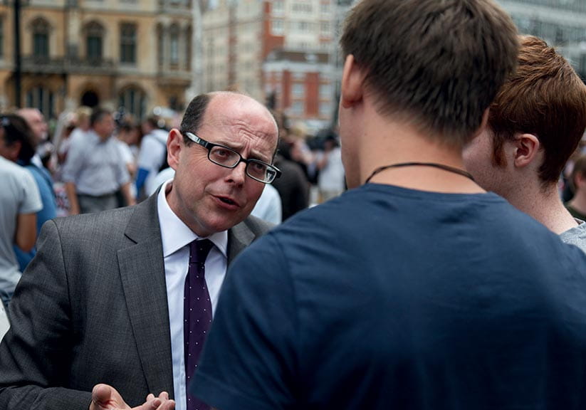 Nick Robinson talks to people at a demonstration in 2011