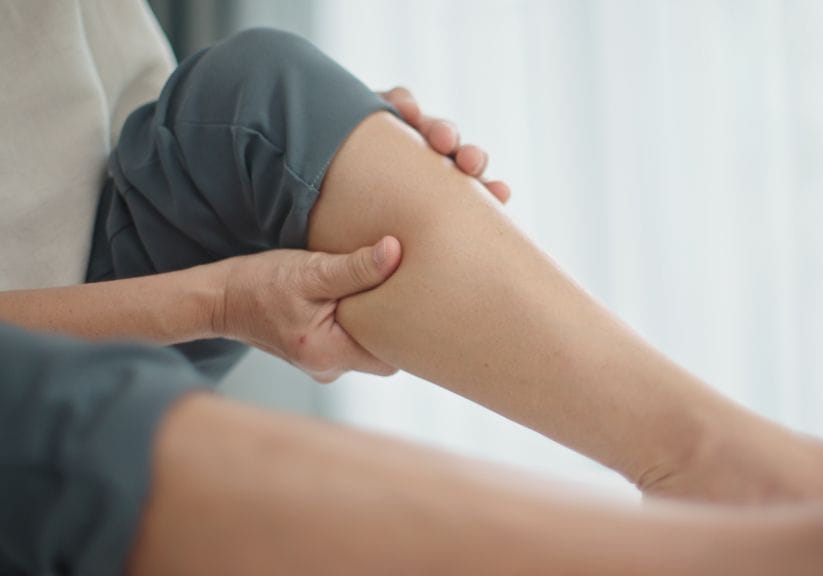 Woman massaging her own calves
