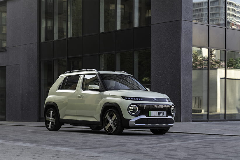 A Hyundai Inster parked in a modern city environment
