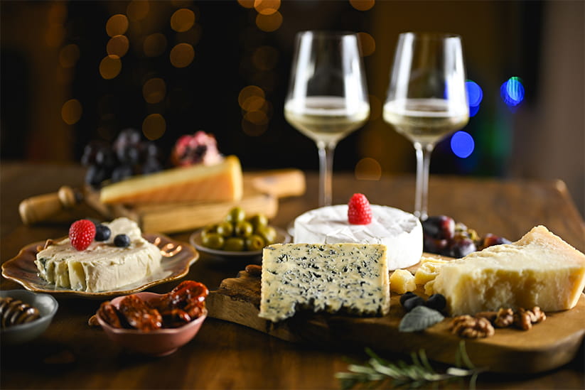 Gourmet cheese board with white wine