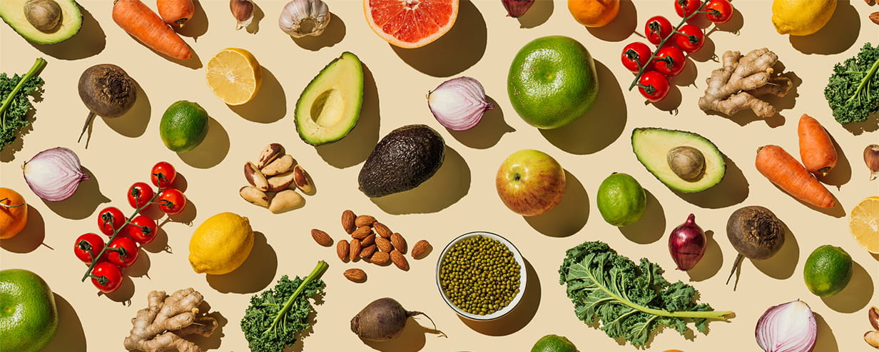 Pattern of variety fresh of organic fruits and vegetables and healthy vegan meal ingredients on beige background.